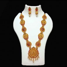 Temple Jewellery with Maata laxmi pendant adorned with matte rani & bottle-green stones